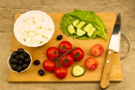 Home cooking summer Greek salad on wooden backgroundの写真素材