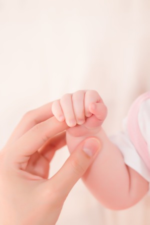 Concept of love and family. hands of mother and baby closeupの写真素材