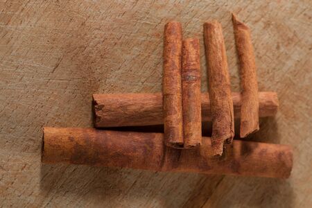whole cinnamon sticks on wooden backgroundの写真素材