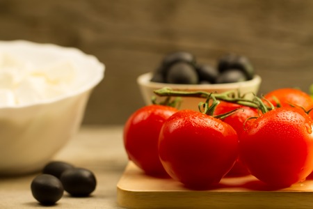 Home cooking summer Greek salad on wooden backgroundの写真素材