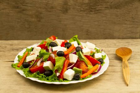 cooking summer Greek salad on wooden backgroundの写真素材