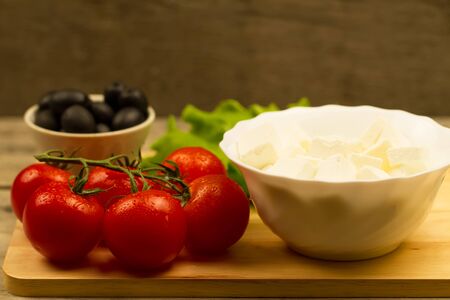 Home cooking summer Greek salad on wooden backgroundの写真素材