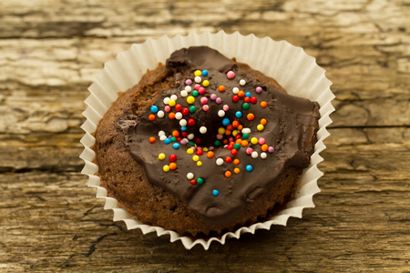 Homemade delicious chocolate cupcake on wooden backgroundの写真素材