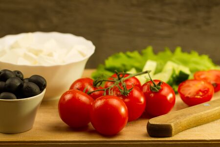 Home cooking summer Greek salad on wooden backgroundの写真素材