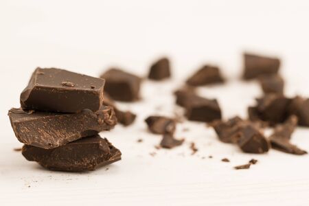 Broken chocolate bar on wooden background, close-upの写真素材