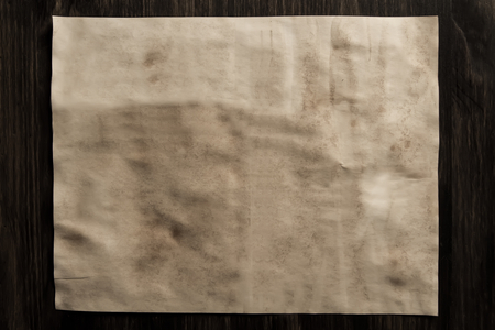 sheet old vintage paper on the aged wooden backgroundの写真素材