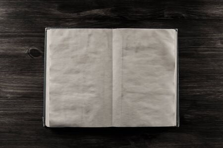 open old vintage book on the aged wooden background