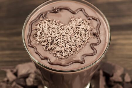 delicious chocolate shake with heart on wooden backgroundの写真素材