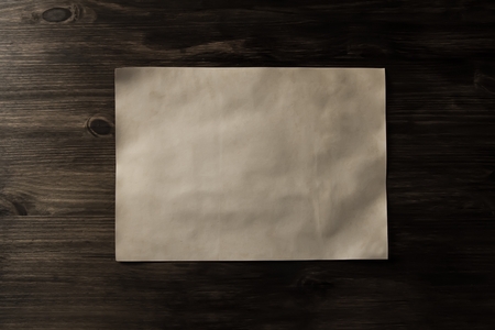 sheet old vintage paper on the aged wooden backgroundの写真素材
