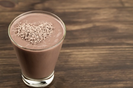 delicious chocolate shake with heart on wooden backgroundの写真素材