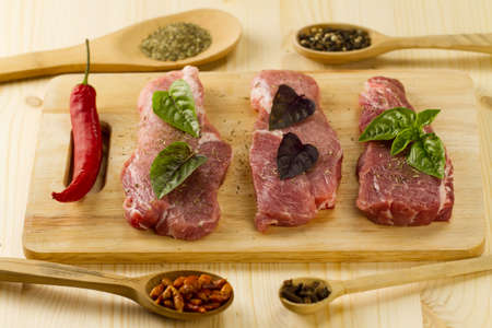 fresh raw pork on cutting Board with spices and herbsの写真素材