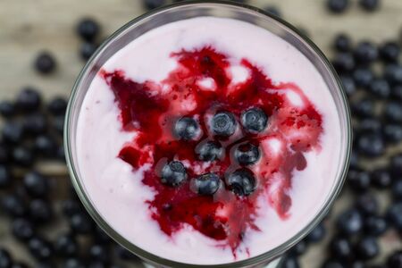 Blueberry smoothie with berries on wooden background. Healthy vegetarian food, diet.の写真素材
