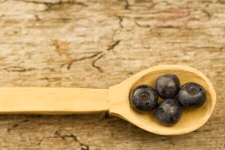 fresh blueberries in spoon on wooden background, close-upの写真素材