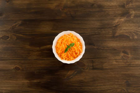 Bunch of fresh carrots with green leaves on wooden . Cooking carrot salad. Healthy vegetarian foodの写真素材