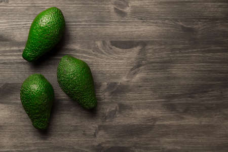 fresh avocados on wooden background. Healthy food, diet. Vegetarian.の写真素材