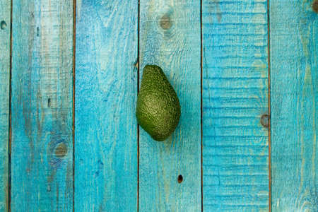 fresh avocados on wooden background. Healthy food, diet. Vegetarian.の写真素材
