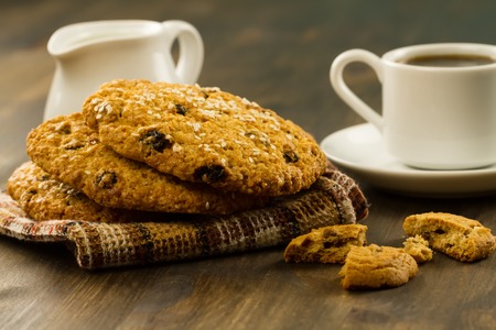 Chocolate chip cookies on an old vintage turquoise wooden background. Set table for breakfast. Hot Cup of coffeeの写真素材