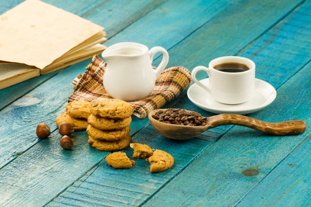 Chocolate chip cookies on an old vintage turquoise wooden background. Set table for breakfast. Hot Cup of coffeeの写真素材