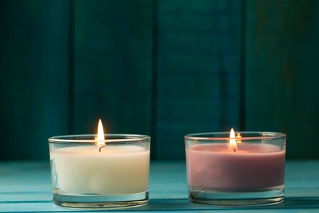 light  burning brightly candles on old wooden background. Spa, meditation, ritual, flavored. turquoise colorの写真素材