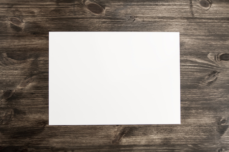 white sheet of paper on old wooden background. Mock upの写真素材