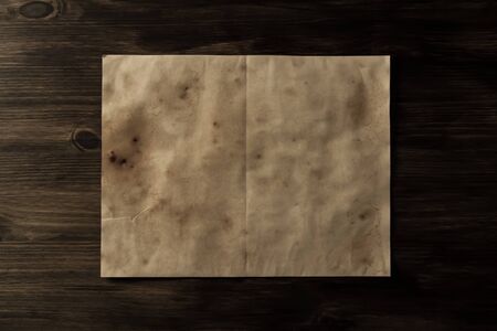 sheet old vintage paper on the aged wooden background. Parchmentの写真素材