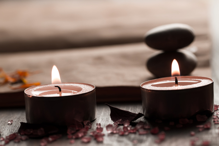 Beautiful Spa composition with aroma candles and empty vintage open book on wooden background. Treatment, aromatherapyの写真素材