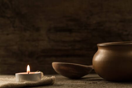 light  burning brightly candles on old wooden background. Spa, meditation, ritual, flavored.の写真素材