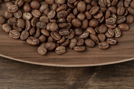 Background coffee. Roasted beans on old wooden backgroundの写真素材