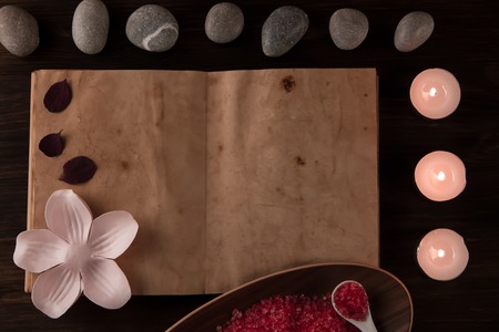 Beautiful Spa composition with aroma candles and empty vintage open book on wooden background. Treatment, aromatherapyの写真素材