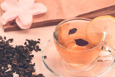 Cup of green tea with lemon on wooden backgroundの写真素材