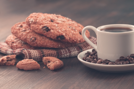 Chocolate chip cookies on an old vintage turquoise wooden background. Set table for breakfast. Hot Cup of coffeeの写真素材