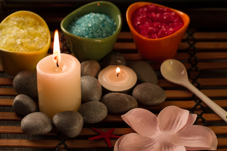 Spa composition with sea salt, candles, soap, shells, creams for face on wooden background. Aromatherapy.の写真素材