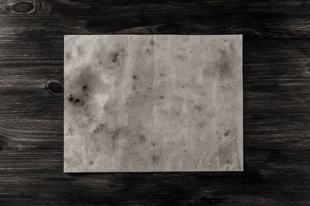sheet old vintage paper on the aged wooden background. Parchmentの写真素材