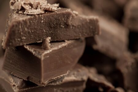 Broken chocolate bar on wooden background, close-upの写真素材