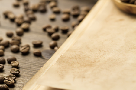 roasted coffee beans on old vintage open book. Menu, recipe, mock up. Wooden background.の写真素材