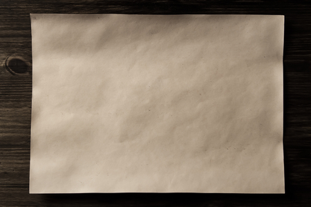 sheet old vintage paper on the aged wooden background. Parchmentの写真素材