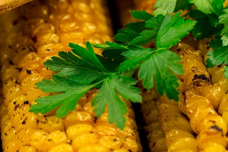 fried corn in a skillet with spices on wooden background. Healthy vegetarian food.の写真素材
