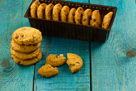 Chocolate chip cookies on an old vintage turquoise wooden background.の写真素材