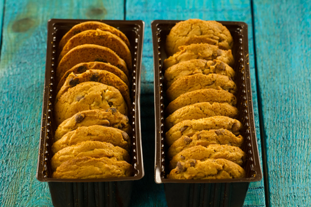 Chocolate chip cookies on an old vintage turquoise wooden background.の写真素材