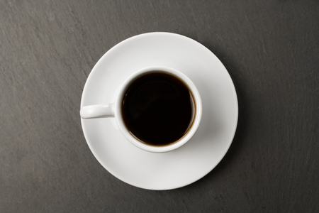 white black Cup of coffee on a black background.の写真素材