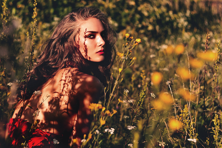 Woman in the garden. Girl flowers landscape.の写真素材