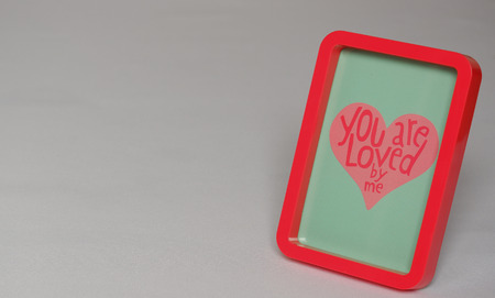 Red photoframe with text in heart blue gray backgroundの写真素材