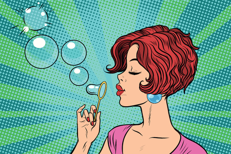 Young woman blowing bubblesの写真素材