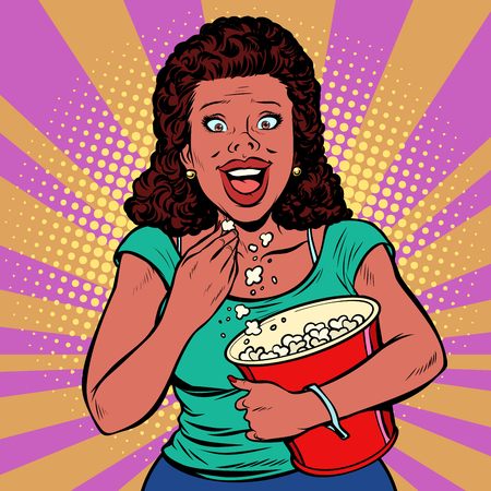 Woman watching a movie, smiling and eating popcorn. Fast food in the cinema hall. Pop art retro vector illustration comic cartoon vintage kitschの写真素材