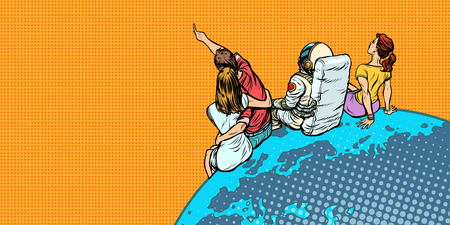people and an astronaut sitting on planet Earth watching the skyの写真素材