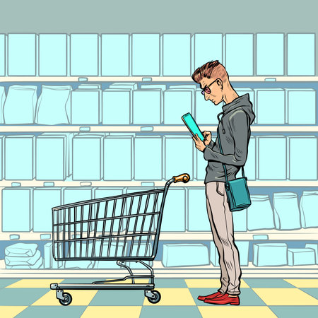 A young man with a grocery cart in the store looks at the phone. Online product selection. Electronic commerceのイラスト素材