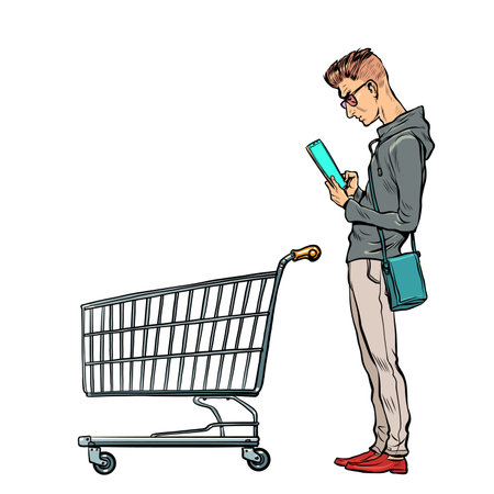 A young man with a grocery cart in the store looks at the phone. Online product selection. Electronic commerceのイラスト素材