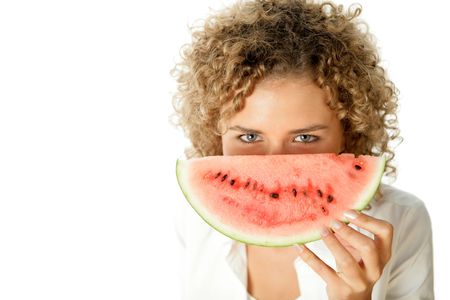 Young woman eating watermelonの写真素材