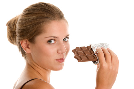 Teenage girl eating chocolateの写真素材