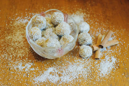 Coconut candies. Some Coconut Pralines close-up shot on wooden background.の写真素材